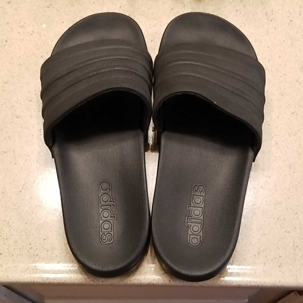 Black on black Adidas memory foam slides